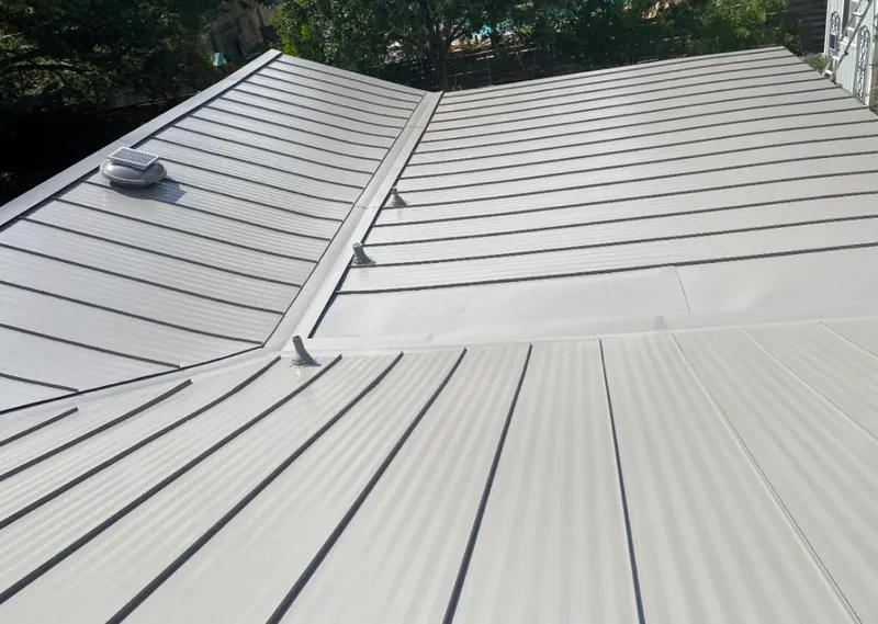 Solar attic fan installed on a metal roof for Roof Ventilation in Toronto