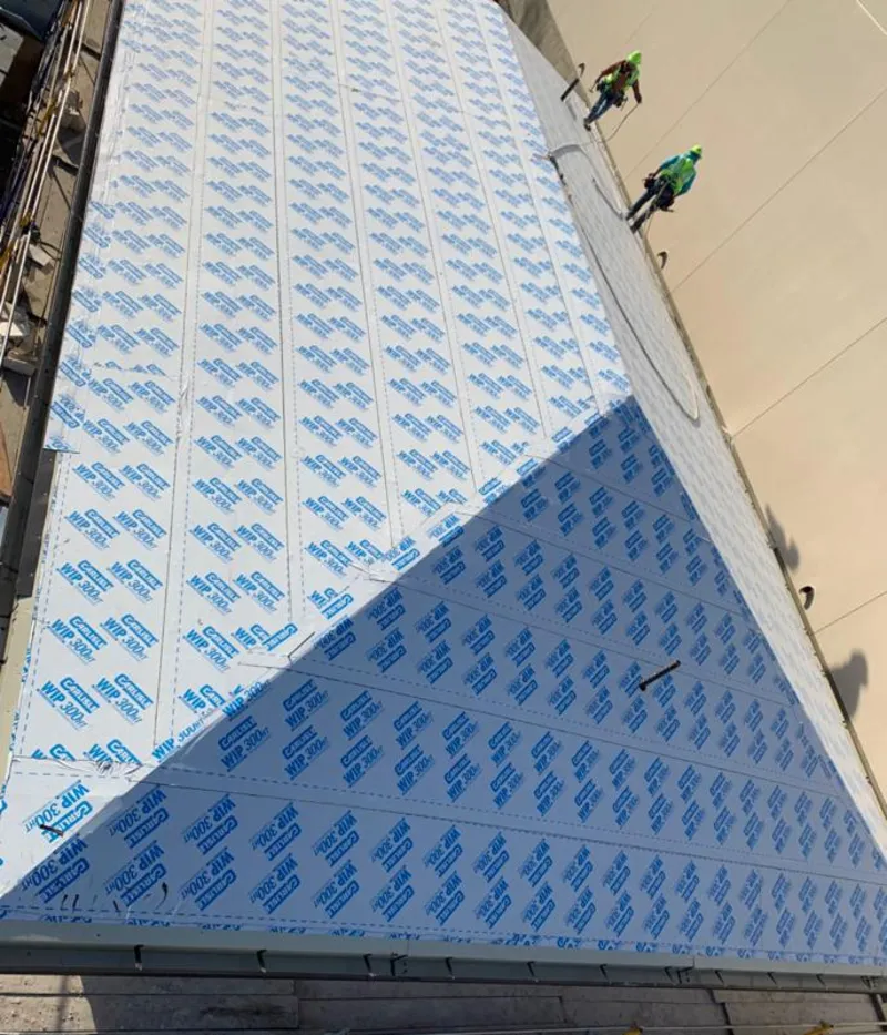 Professional roofers installing underlayment on a metal roof in Toronto